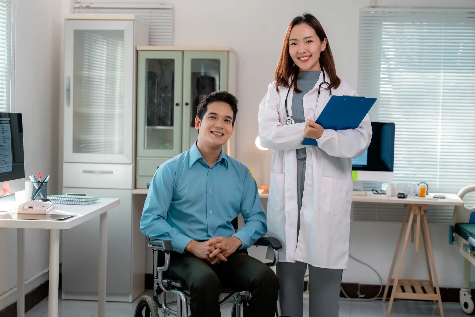Doctor and patient smiling in medical office, promoting healthcare and disability support