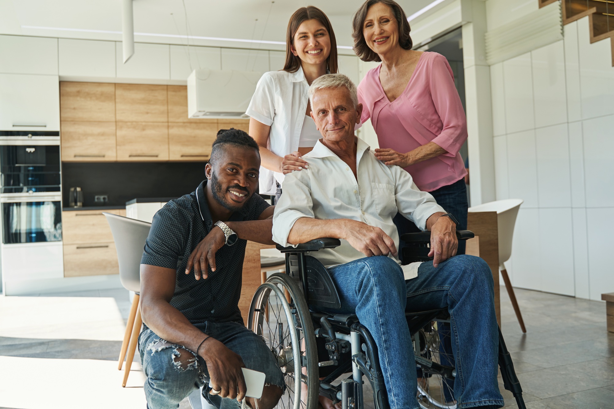 People supporting male with physical disability at home
